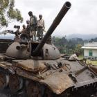 Congolese children play on a destroyed military tank, abandoned by the M23 rebel fighters near...