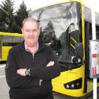 Connectabus owner Ewen McCammon stands beside a new 41-seat Connectabus which entered service...
