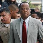 Conrad Murray, Michael Jackson's doctor, is escorted by Los Angeles County Sheriffs deputies as...