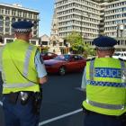 Constable Dave Bullot (left) and Senior Constable Brad Taylor keep an eye on the intersection of...