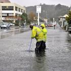 Contractors clear a blocked drain in Harbour Tce, Dunedin, about 11.30am yesterday. Photo by ...