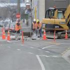 Contractors remove a traffic island at the intersection of Anzac Ave and Castle St, making it...