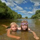 Cousins Molly and Jessica Lynch (both 8) cool  in the shallows of the Taieri River at Outram Glen...