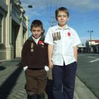 Cousins Seth Rogan (6), of Milton with his great-great-great-uncle's medal, and Jordan Rogan (9),...