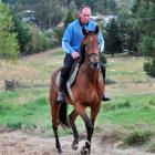 Craig Graham, son of trainer Noel Graham, trots Richard Trimbole on the circular sand track at...