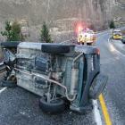 A woman driver was pulled to safety by passing motorists when her vehicle crashed in the Kawarau...