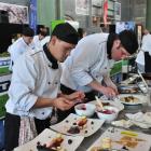 Cumberland College chefs Dylan Henry (left) and Brian King put the finishing touches to their two...