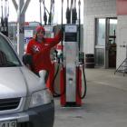 Curson Motors employee Fiona Laurence fills up a car on Tuesday morning when the service station...