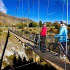 Cyclists admire the view from The Edgar Bridge on  the Queenstown Trail.  Concerns have been...