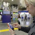 Daisuke Tsuda tweets with his mobile phone at a station in Tokyo. "Japan is enjoying the richest...