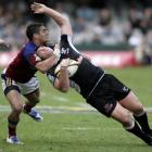 Daniel Bowden, of the Highlanders, tackles Riaan Swanepoel, of the Sharks, during their teams'...