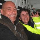 Daryl Hewer and Jinney Neale (both 49), of Haast, on the helicopter flying them to safety after...