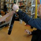 Dave Dobbyn signs a guitar for Harrison Croy (9), of Clyde, as he celebrates the release of his...