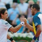 David Ferrer (L) of Spain shakes hands with Jo-Wilfried Tsonga of France after winning their men...
