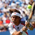 David Ferrer of Spain hits a return to Kevin Anderson of South Africa during their men's singles...