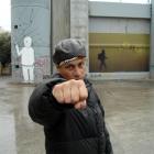 Dean Hapeta in Bethlehem next to a wall that separates Palestinian and Israeli communities.