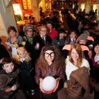 Decked out in cloaks and waving wands, residents and residents' family members (front, from left)...