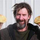 Delivery driver Neil Meyer with two of the Highland meat pies produced at Gore’s Oven Fresh Bakery.