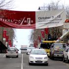 Delta workers remove the Otago Festival of the Arts banner from George St, Dunedin, yesterday...