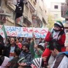 Demonstrators hold a banner during a protest against Syria's President Bashar al-Assad after...