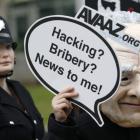 Demonstrators protest outside the News International offices in East London yesterday. REUTERS...