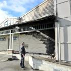 Detective Sergeant Brett Roberts examines the fire-damaged King's High School gymnasium, on...