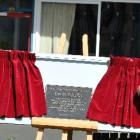 Dion Latta's parents, Sue and Logan Latta, unveil the memorial plaque to their son at John...