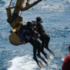 Divers Simon Mitchell and Pete Mesley are picked up by a digger bucket after an attempt to...