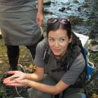 Doc coastal Otago freshwater ranger Lan Pham shows off some of the aquatic life in Oamaru Creek.