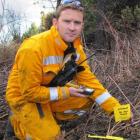 Doc Wakatipu fire investigator Jaime Cowan holds a GPS on Wednesday to way point a piece of...