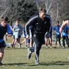 Doing a running drill with Brad Thorn during an All Black visit to Cromwell yesterday are...