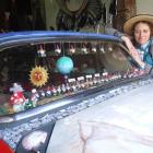 Donna Demente with the art car she is redecorating. Photo by Sally Rae.