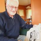 Doug Grant looks over some of his old rugby photographs at his Oamaru home yesterday. Photo by...