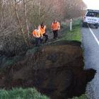 Downer contractors examine the washed-out culvert on State Highway 1 south of Waipahi yesterday...