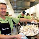 Downie Stewart Lawyers partner Pieter Brits helps prepare food as part of a FoodShare initiative...