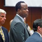 Dr Conrad Murray stands with his attorneys J. Micahel Flanagan and Edward Chernoff during his...