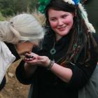 Dr  Jane Goodall  on a previous visit to Orokonui, gets to smell Kiwi poo. Photo by Neville Peat.