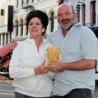 Dragon Cafe waitress Lyn Kennedy holds a piece of the parapet that crashed down around her ...