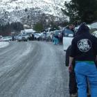 Drivers bound for Coronet Peak fit, or attempt to fit, snow chains on over 20 vehicles including...