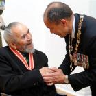 Dunedin artist Ralph Hotere is congratulated by New Zealand Governor-General Sir Jerry Mateparae...