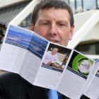 Dunedin City Council communications and marketing manager Graham McKerracher checks  a copy of...