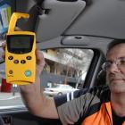 Dunedin City Council meter technician Paul Johnson demonstrates the new SmartPark device in...