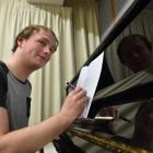 Dunedin composer Sam van Betuw works on his latest composition as he waits for another of his...