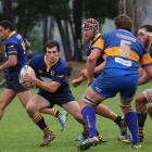 Dunedin first five Greg Dyer looks for some attacking options against a determined Taieri defence...
