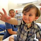 Dunedin Hospital children's ward nurse Colette Helleur with 18-month-old Brendan Forbes, who is a...