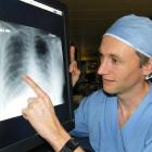 Dunedin Hospital ICU consultant Dr Matthew Bailey examines an X-ray of the air-starved lungs of a...