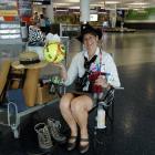 Dunedin International Airport customer services officer Clare  Doherty sits yesterday with some...