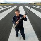 Dunedin International Airport fire officer Bruce Smaill patrols the airport daily, scaring and...
