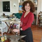 Dunedin jeweller Lynn Kelly stands beside an anvil in Lure Gallery. Photo supplied.