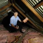 Dunedin landlord Grant Roydhouse inspects the insulation installed in one of his properties under...